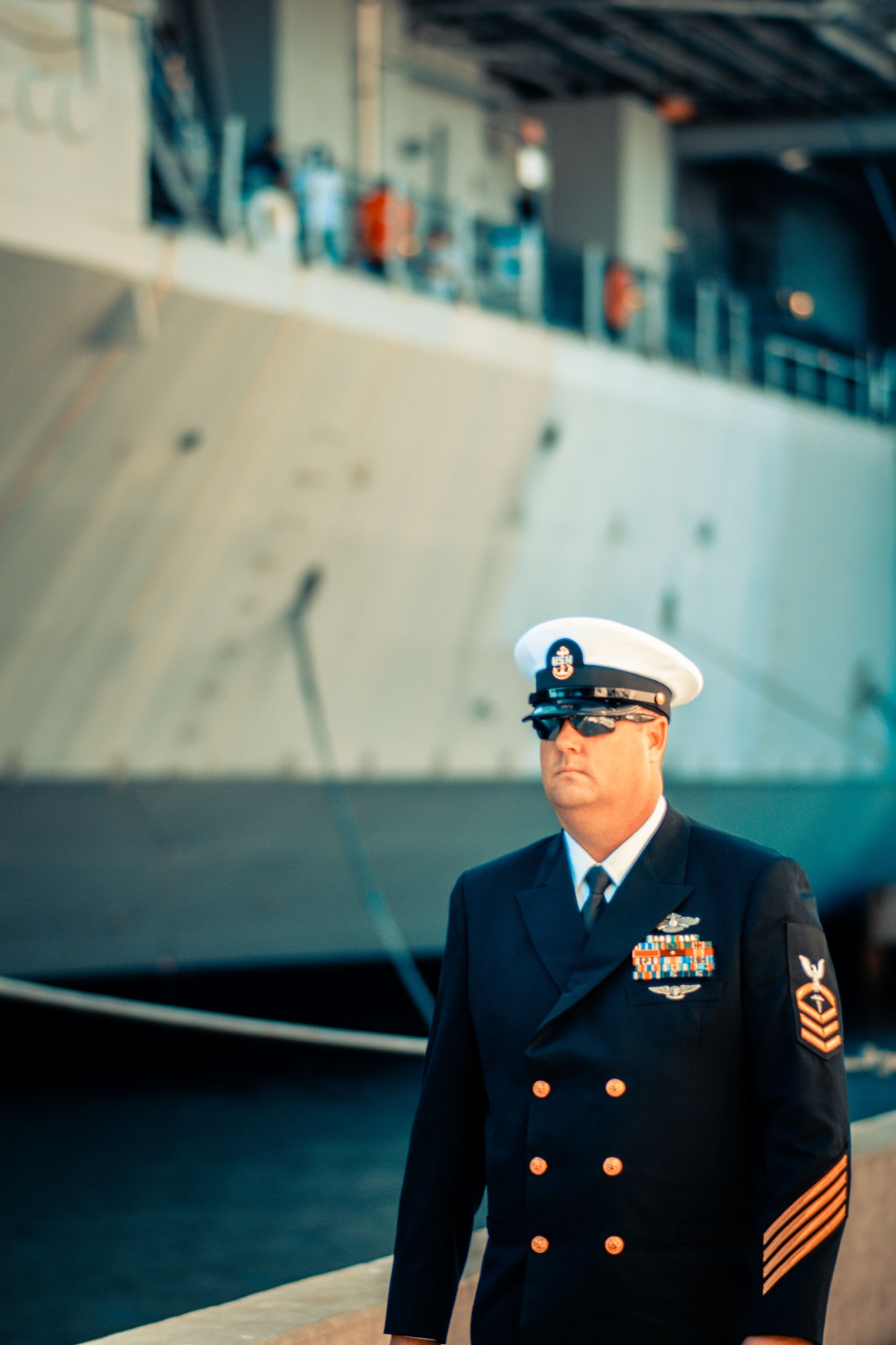 A Navy officer standing in front of a ship