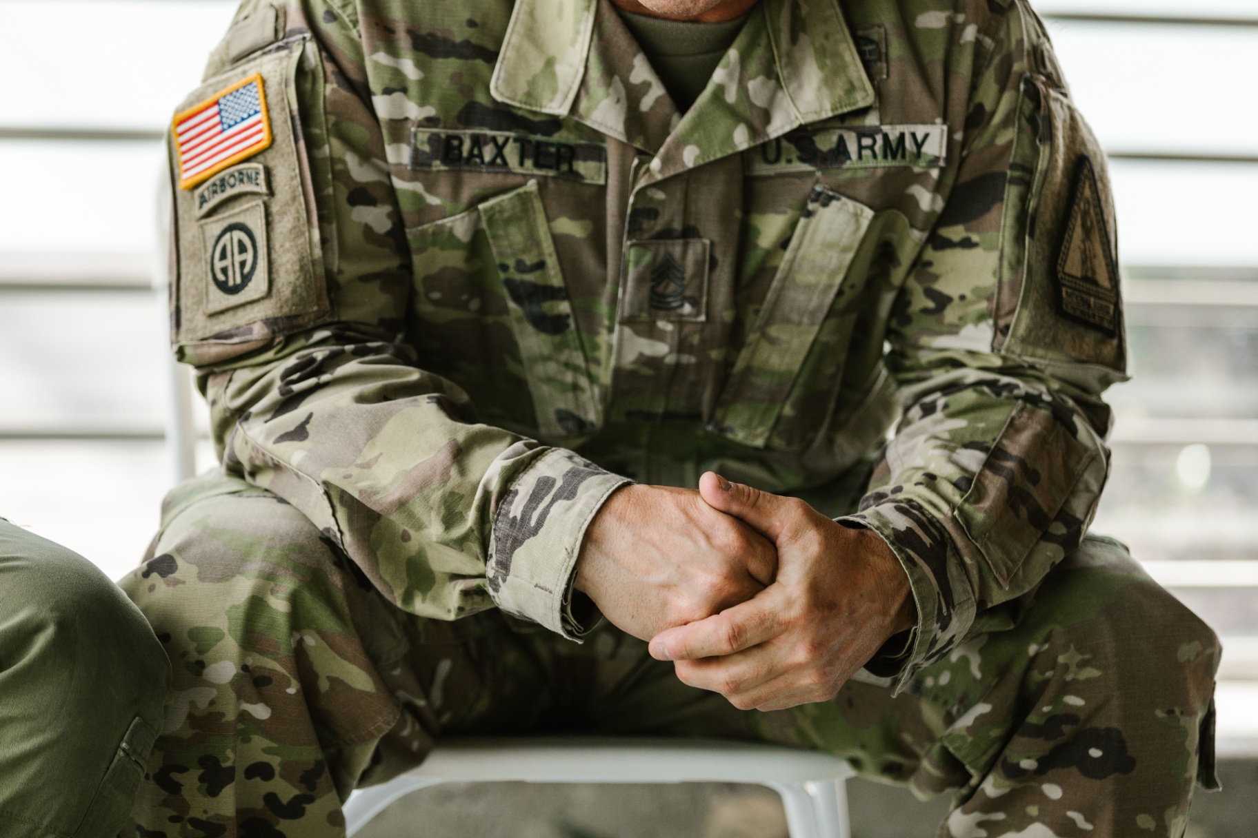 A U.S. Army veteran with hands clasped, considering their next step